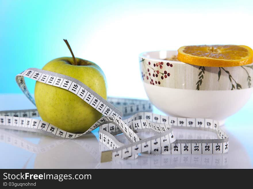 Bowl of corn flakes with green apple and measuring tape. Bowl of corn flakes with green apple and measuring tape