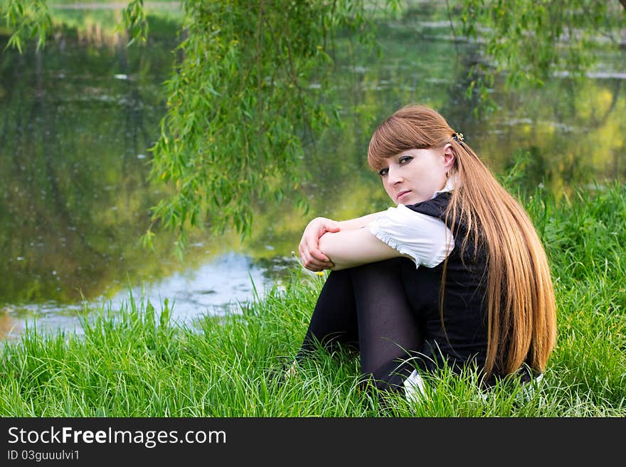 Beautiful woman relaxing at the park near lake. Beautiful woman relaxing at the park near lake