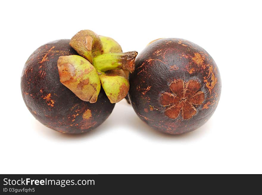 Two mangosteens isolated on white