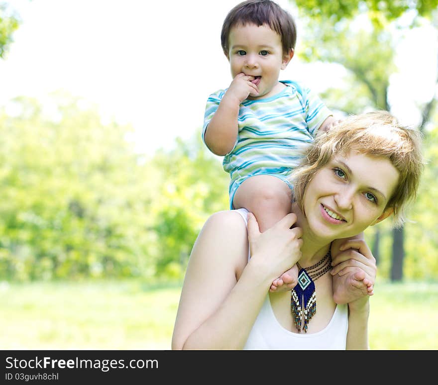 Young mother with little son at the park. Young mother with little son at the park