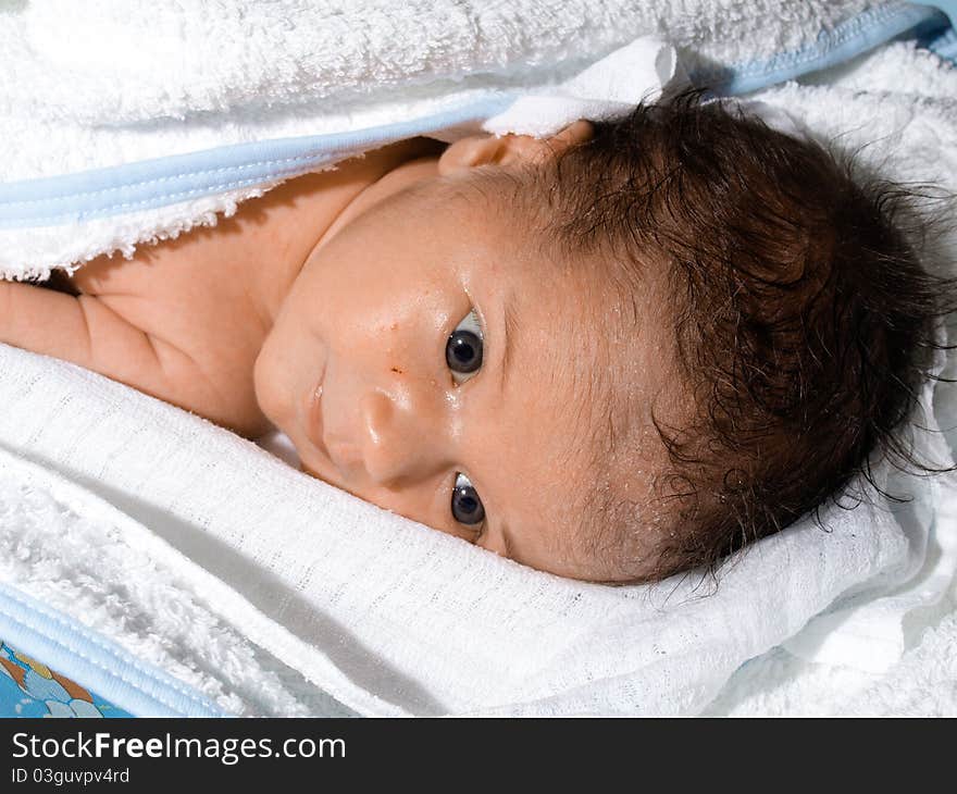 Very little baby born, after warm bath child lies in white towel. Very little baby born, after warm bath child lies in white towel