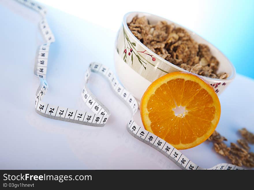 Corn flakes with fruits and measuring tape. Corn flakes with fruits and measuring tape