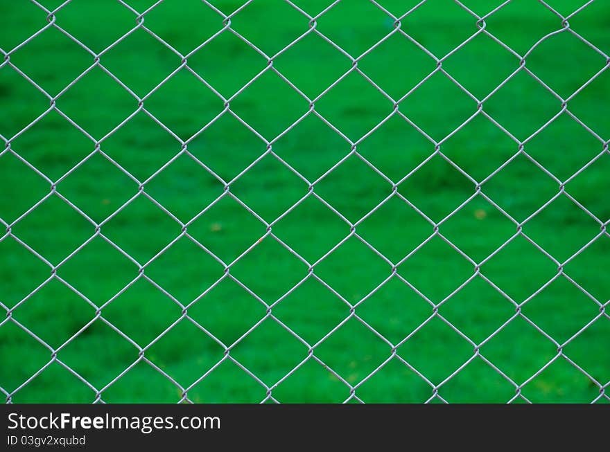 Iron wire fence green background