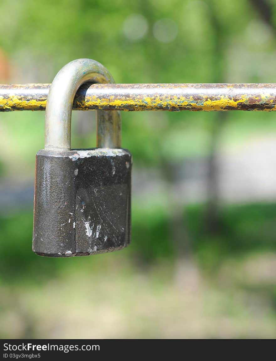 Old rusty lock on green background