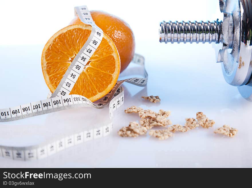 Orange with measuring tape and dumbells. Orange with measuring tape and dumbells