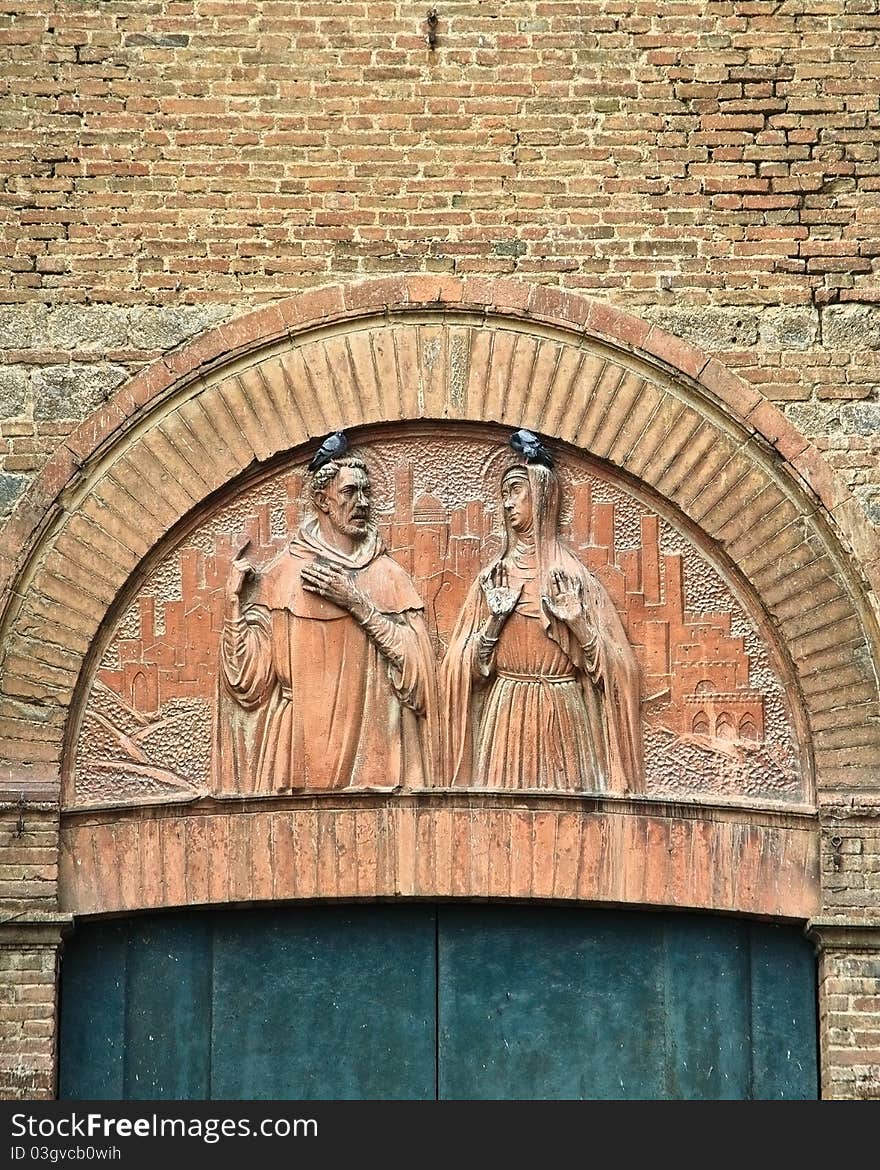 An arch with religious carvings over a door in a cathedral in Siena, Italy. An arch with religious carvings over a door in a cathedral in Siena, Italy