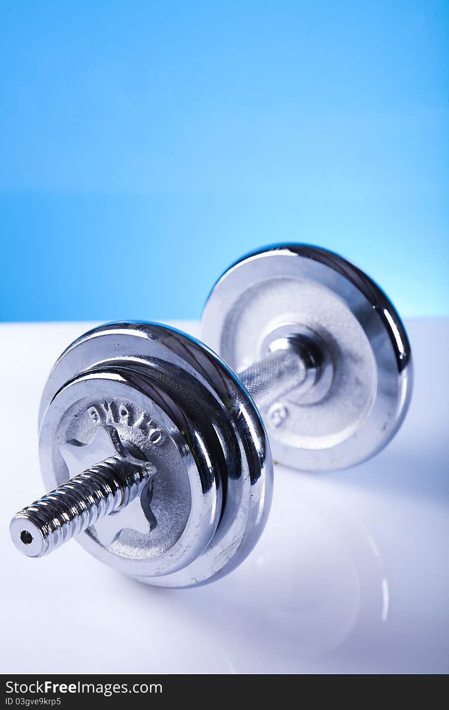 Dumbells on the blue background