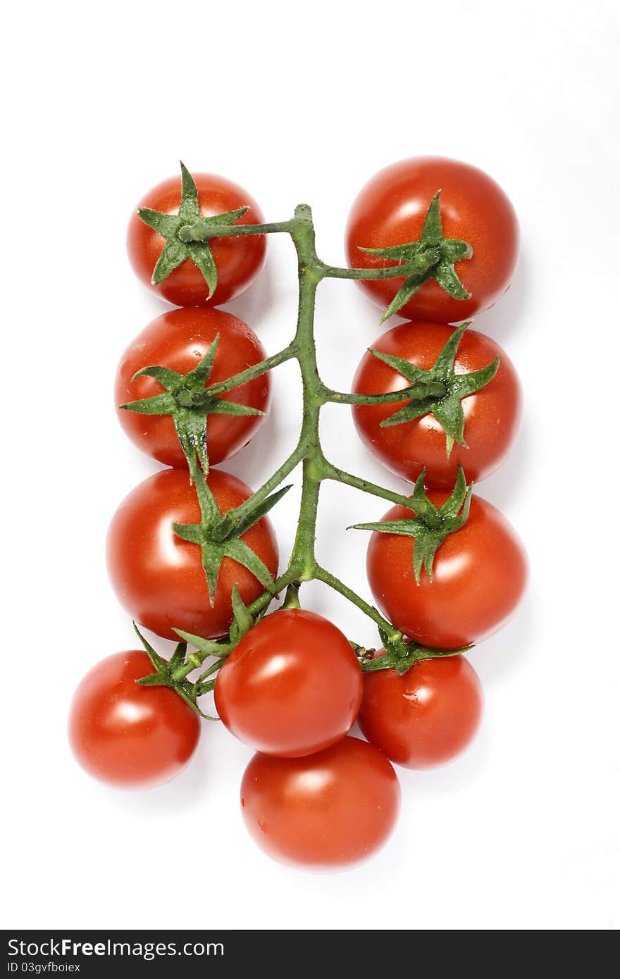 The close-up of a bunch of small red tomatoes