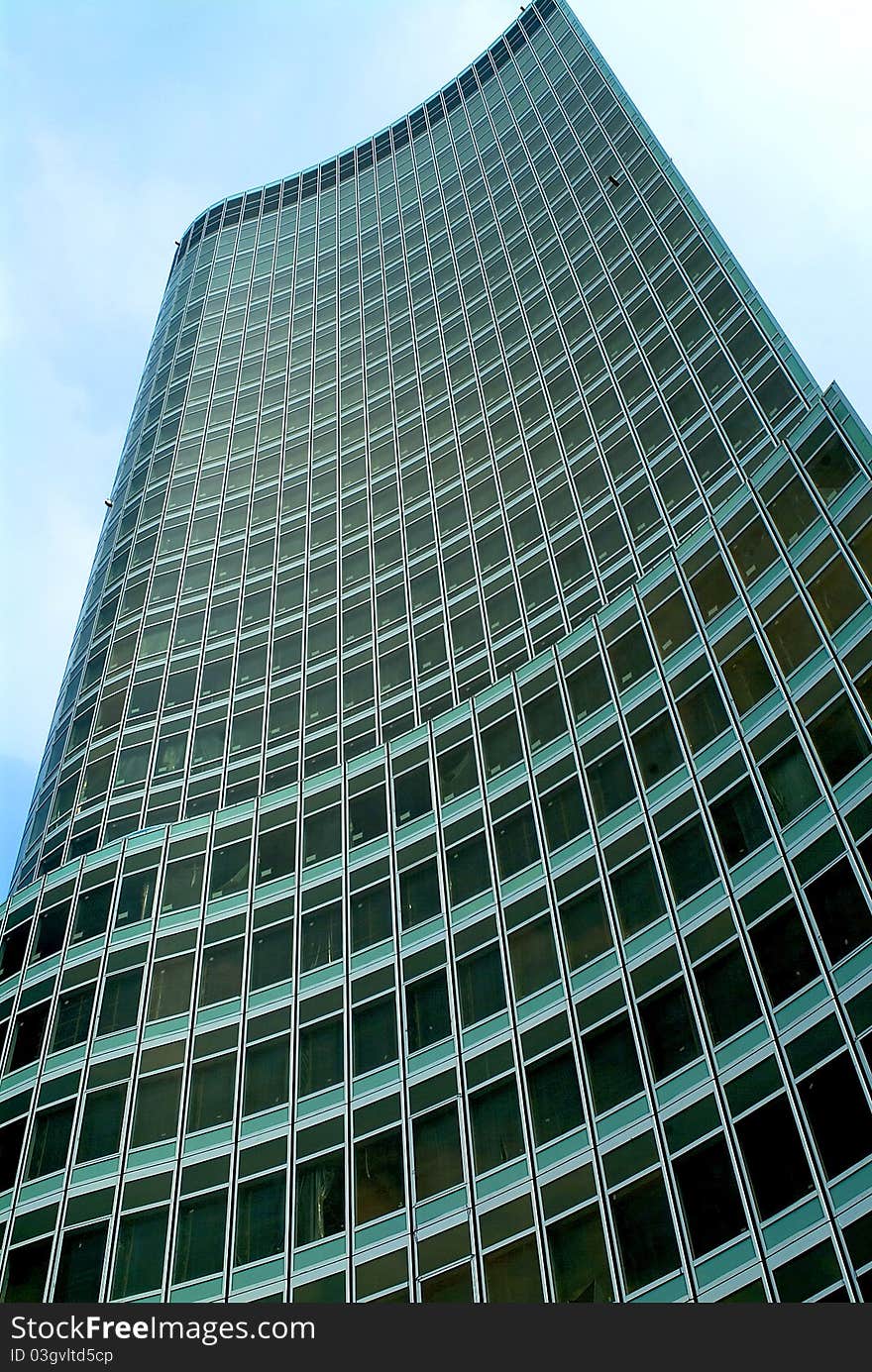 Modern high-rise streamline commercial building upward-view. Modern high-rise streamline commercial building upward-view