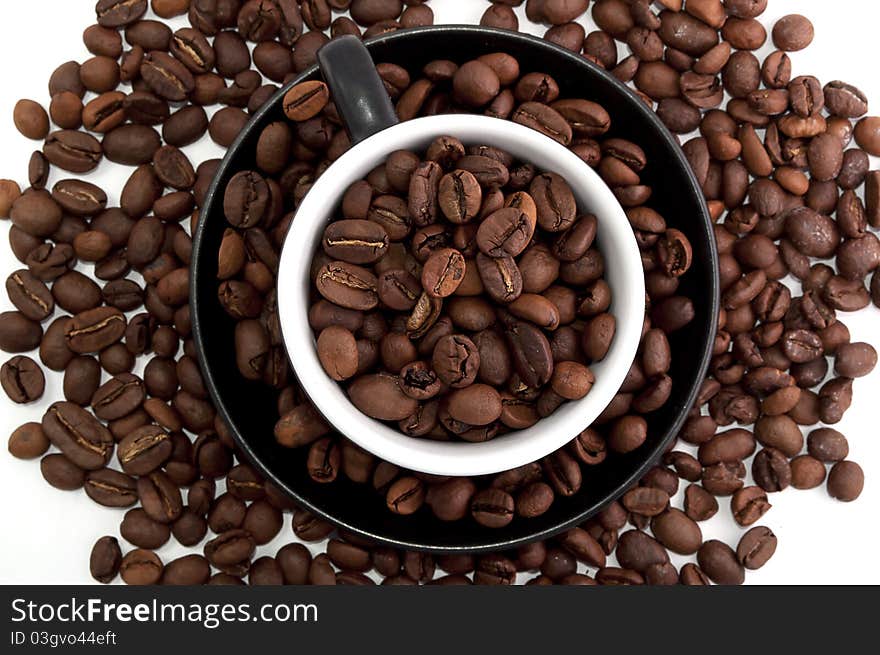 Cup of coffee beans isolated on white