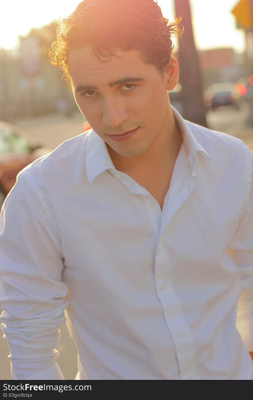 Backlit photo of a young man at sunset outdoors. Backlit photo of a young man at sunset outdoors