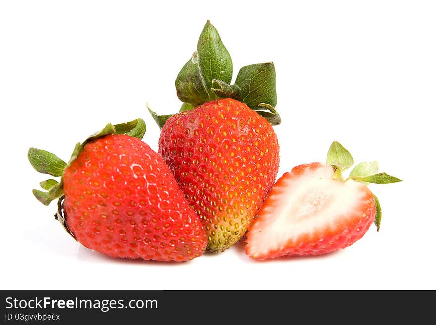 Image of two isolated strawberries, one of them is sliced in half. Image of two isolated strawberries, one of them is sliced in half.