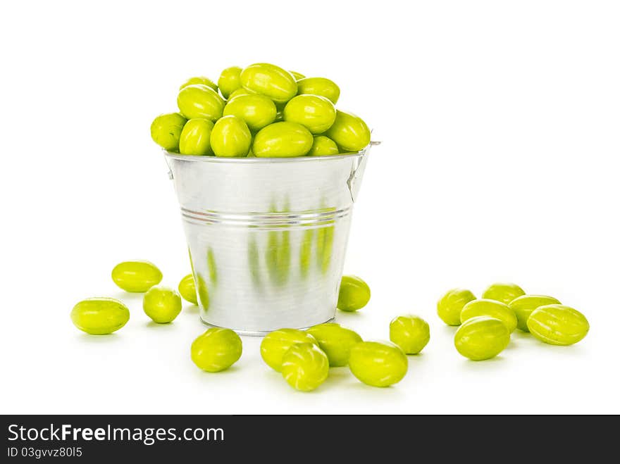 Lots of colorful flowers in a steel bucket. Isolated on white background. Lots of colorful flowers in a steel bucket. Isolated on white background