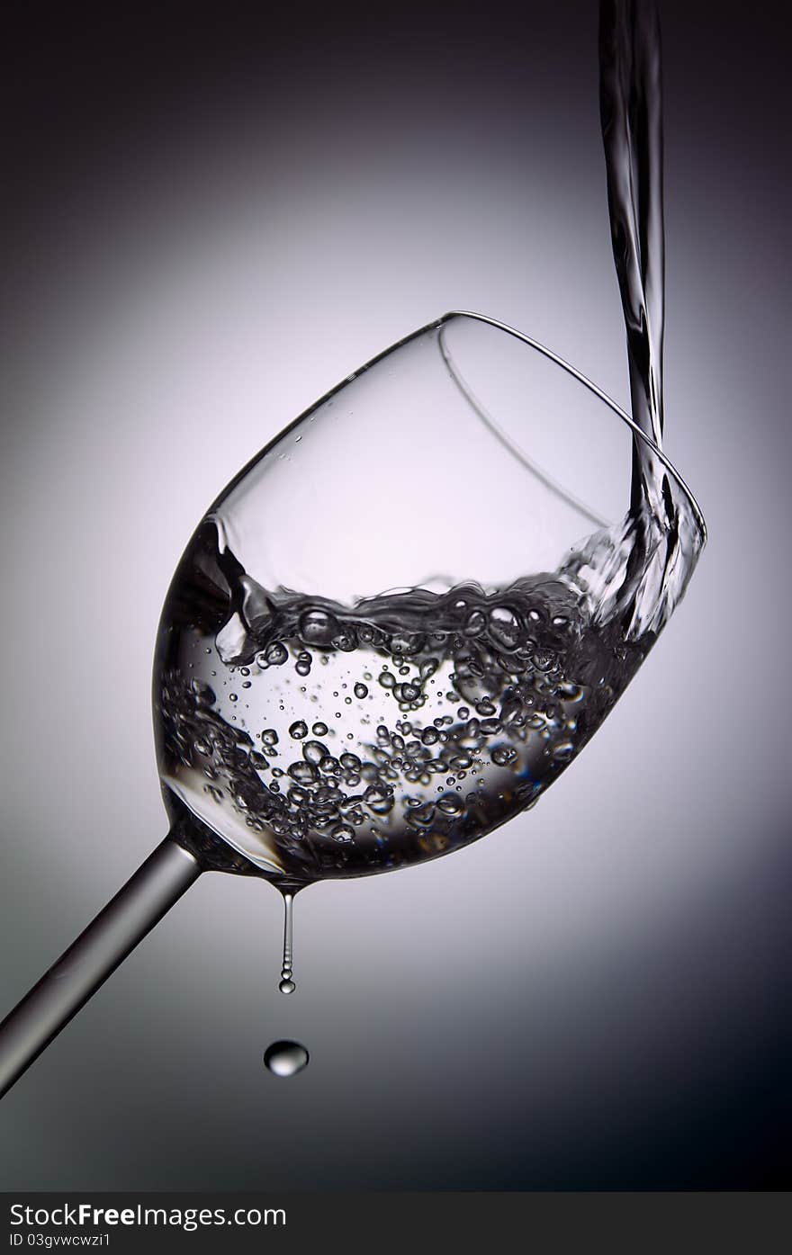 Filling a glass of water in white and dark background