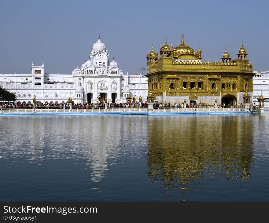 Close up of the Golden Temple with holy nectar tank and Clock Tower. Close up of the Golden Temple with holy nectar tank and Clock Tower