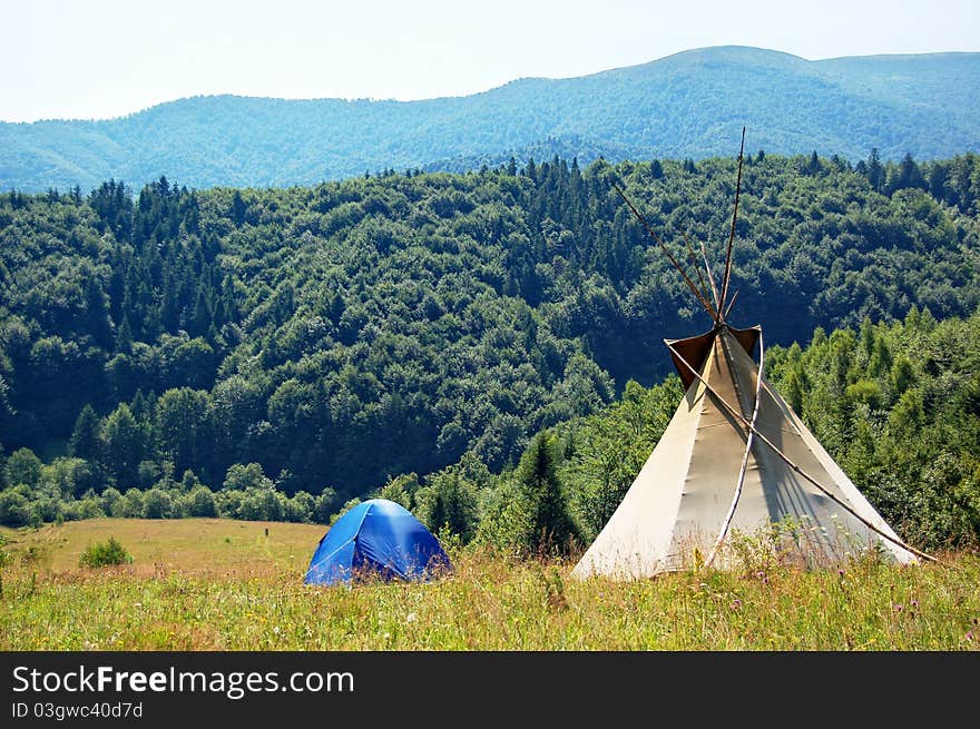 Mountain view with tent and teepee