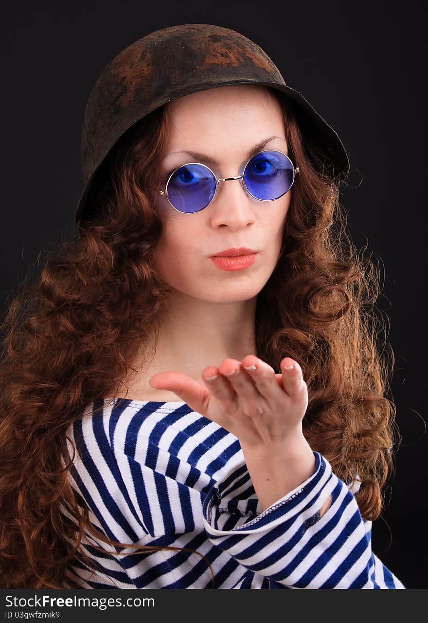 Emotional portrait of a girl in a vest and a military helmet. Emotional portrait of a girl in a vest and a military helmet