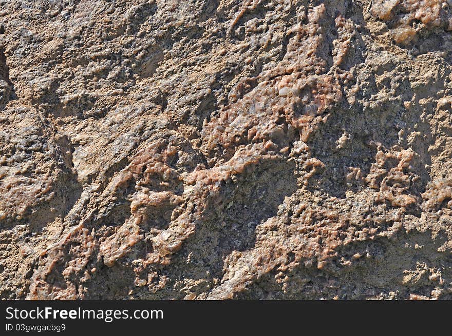 Fragment of natural brown stone surface background texture. Fragment of natural brown stone surface background texture