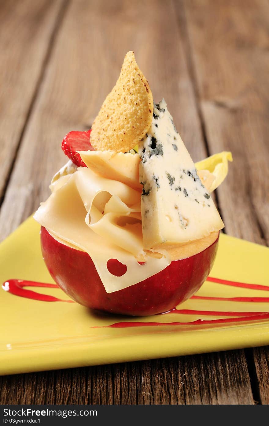 Various types of cheese and red apple. Various types of cheese and red apple