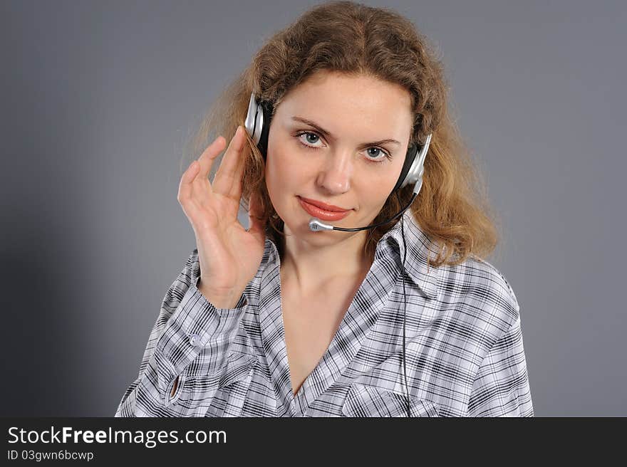 Female customer service representative in headset, on a grey background