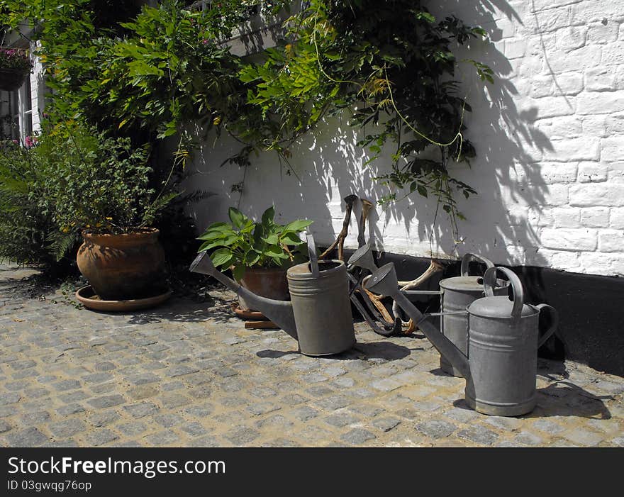 Collection of watering cans in a small country house. Collection of watering cans in a small country house