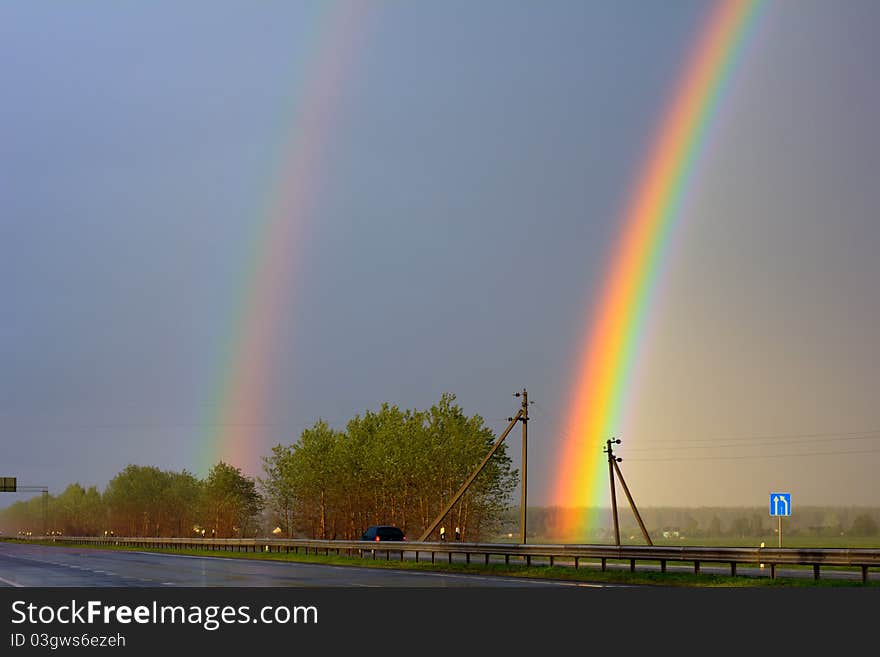 Landscape with two rainbows over Highway