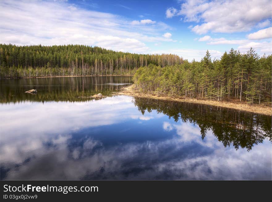 A beautiful lake surrounded by woods, in Finland