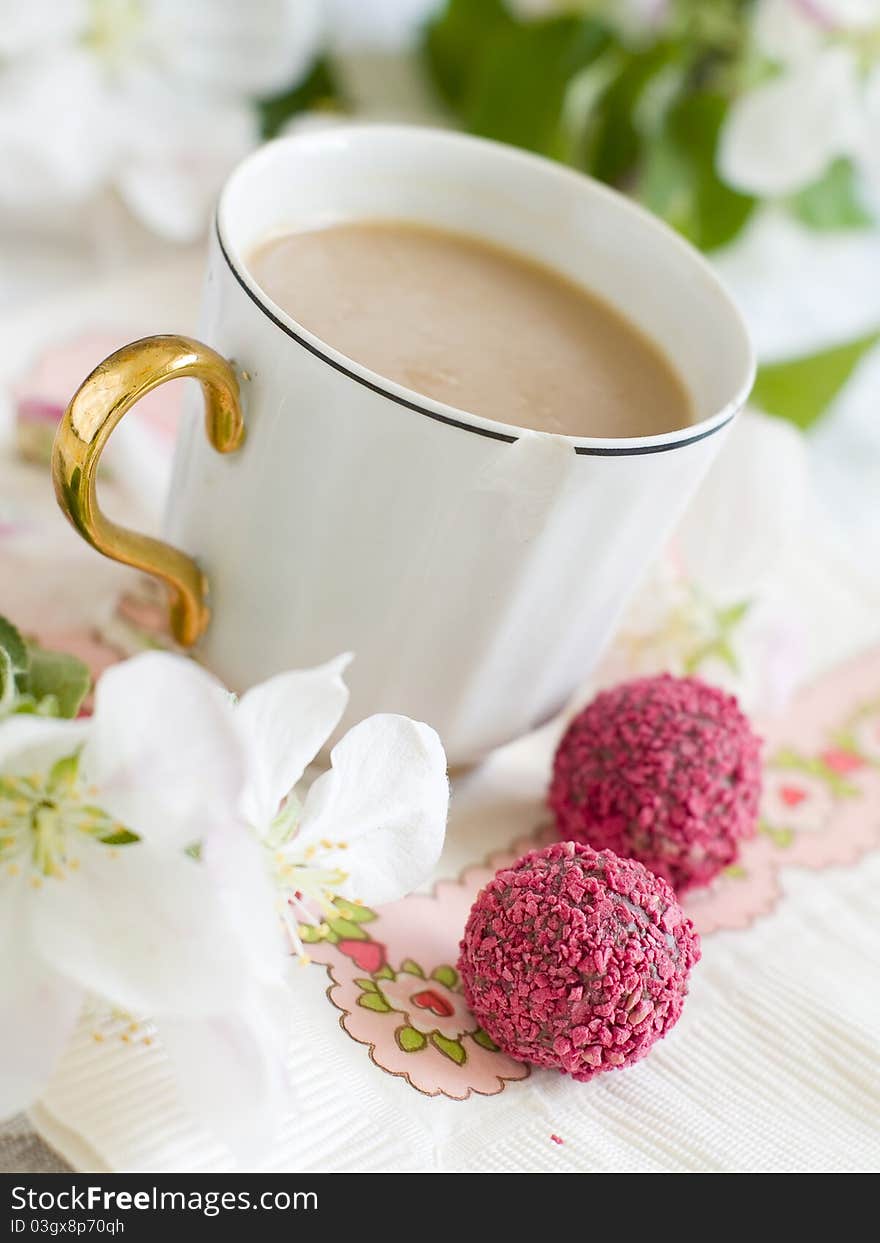 White coffee in old coffee cup with pink candy