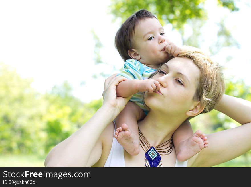 Young mother with little son at the park. Young mother with little son at the park