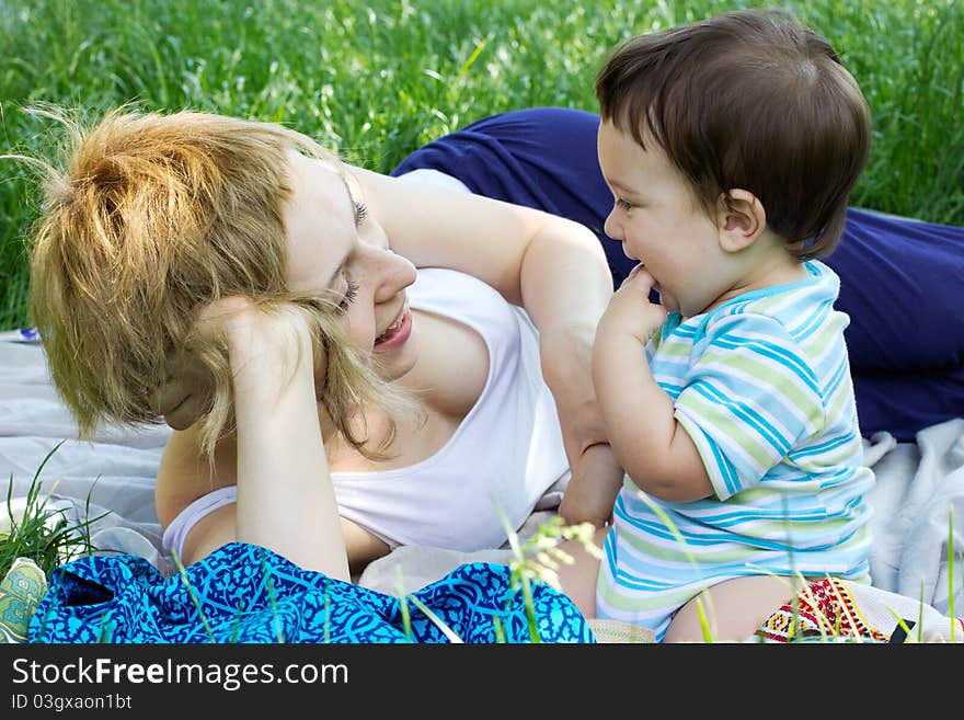 Young mother with little son at the park. Young mother with little son at the park