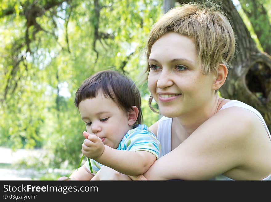 Young mother with little son at the park. Young mother with little son at the park