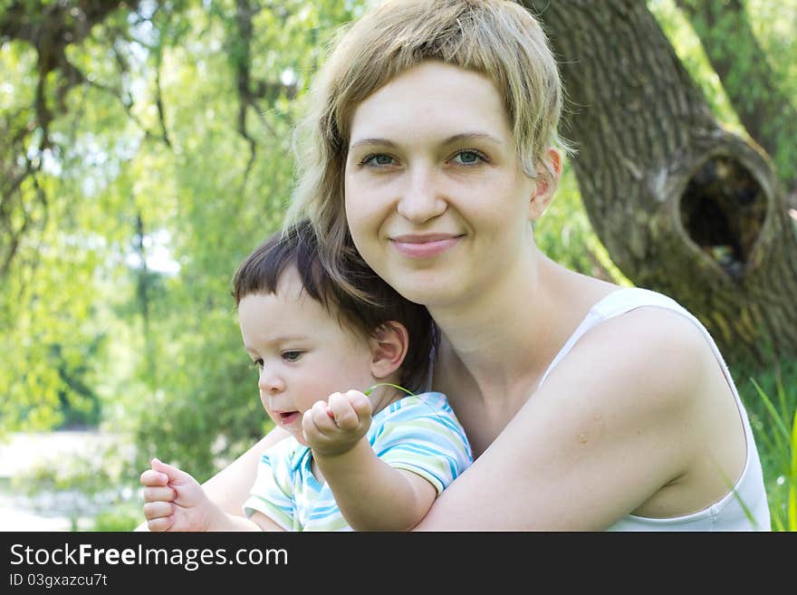 Young mother with little son at the park. Young mother with little son at the park