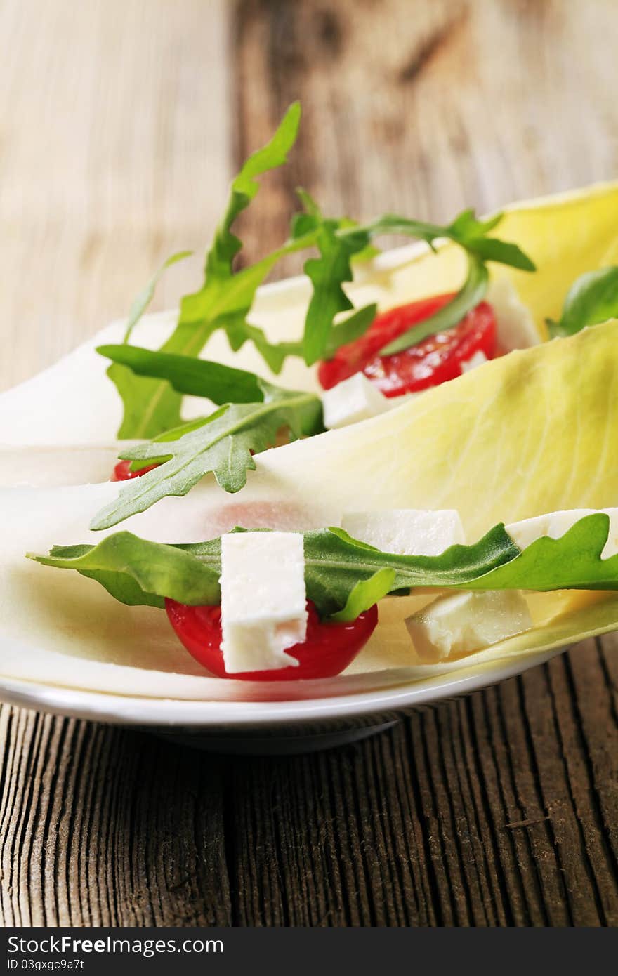 Endive leaves, arugula and diced feta cheese. Endive leaves, arugula and diced feta cheese