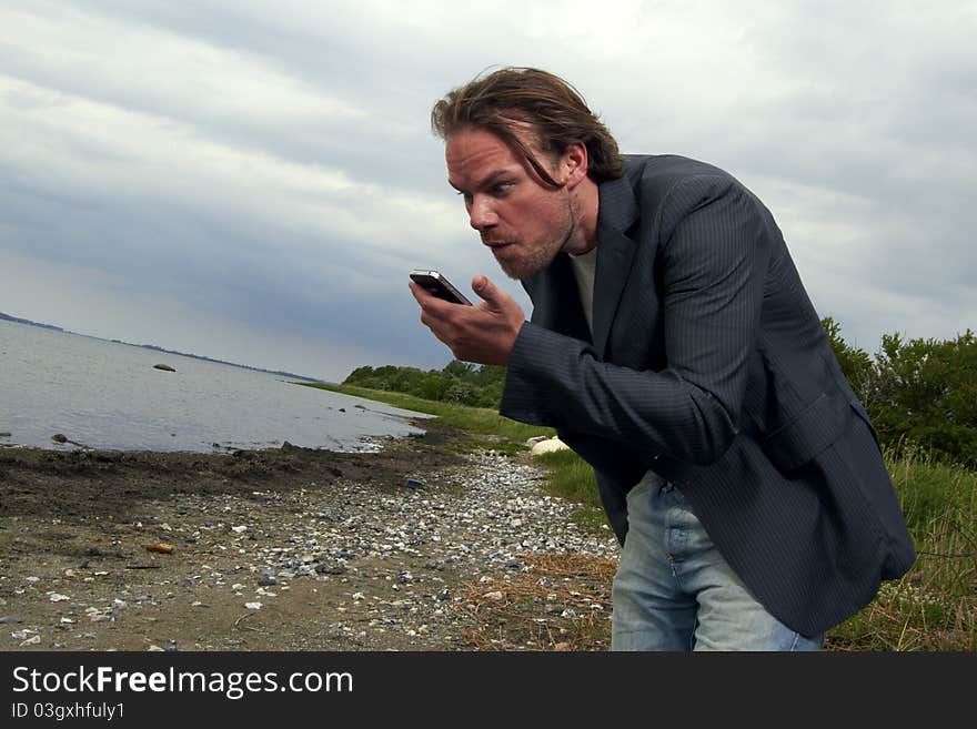 Man with phone on beach