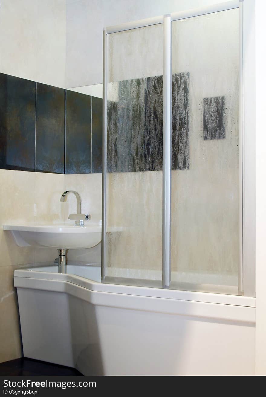 Bathroom interior with bath and washbasin