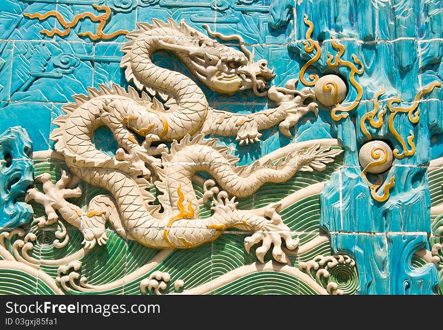 Detail of the Nine-Dragon(Jiu-Long) Wall, in Beijing china. It is made of glaze bricks of seven-colors. Nine complete dragons playing in the clouds decorate both sides of the wall. Detail of the Nine-Dragon(Jiu-Long) Wall, in Beijing china. It is made of glaze bricks of seven-colors. Nine complete dragons playing in the clouds decorate both sides of the wall.