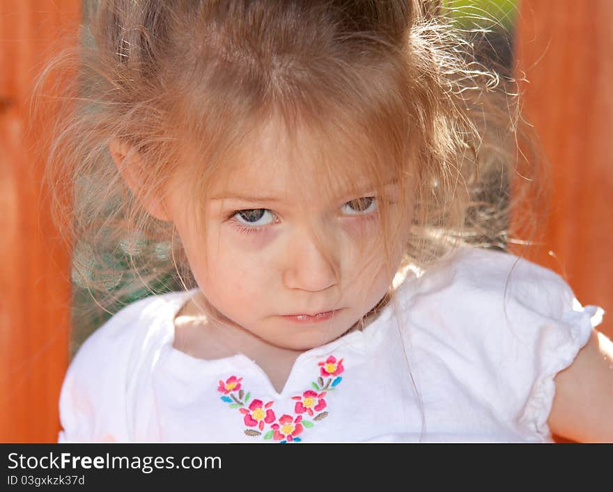 A photograph of an adorable child playing on some playground equipment. A photograph of an adorable child playing on some playground equipment.