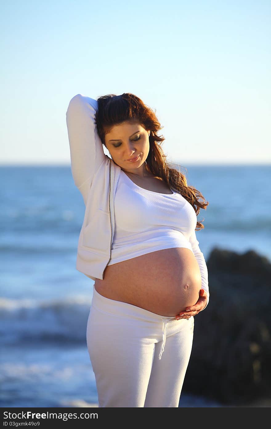 Pregnant Woman At The Beach Raised Hand