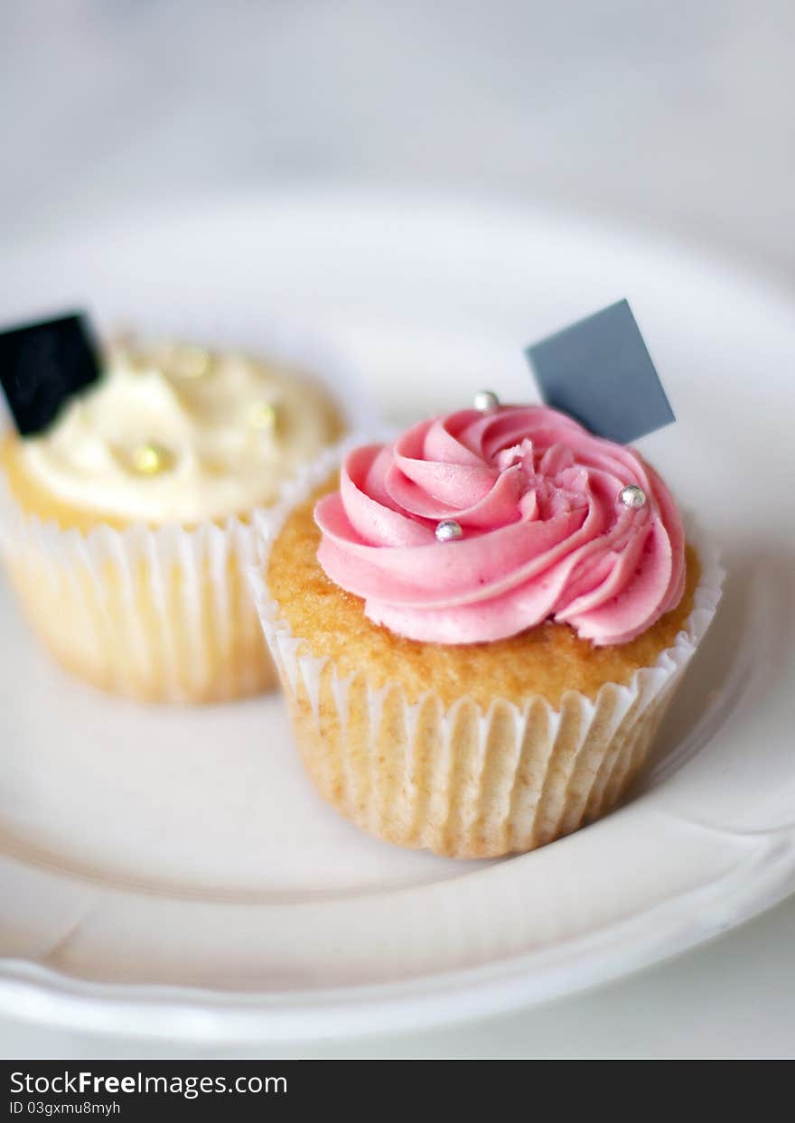 Closeup of two fancy cupcakes in a cafe