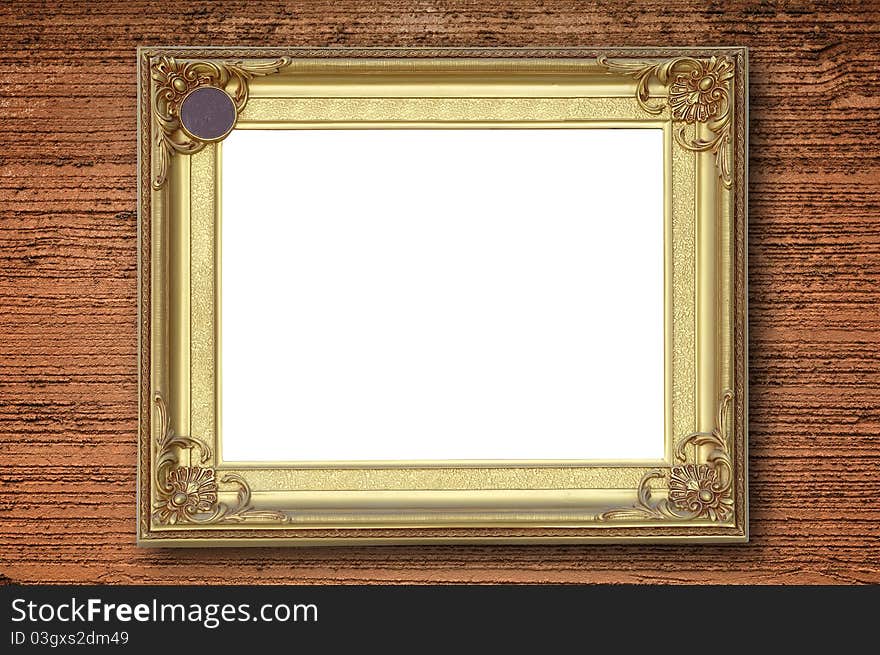 Gold picture frame on rough orange wall.