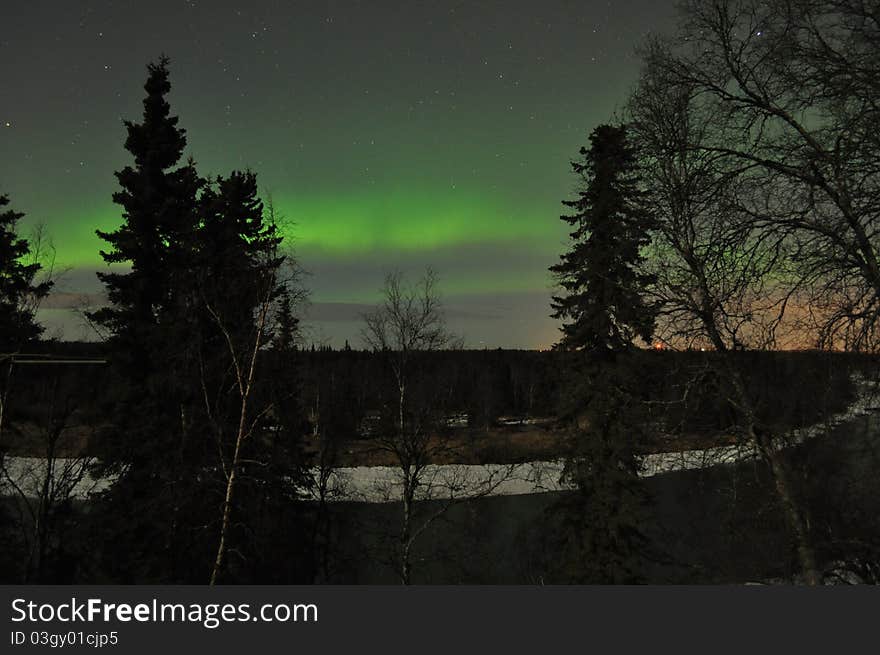 Kenai river alaska with soft green aurora on the horizon. Kenai river alaska with soft green aurora on the horizon