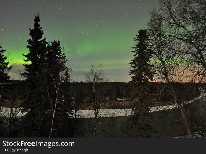 Kenai river alaska with soft green aurora on the horizon. Kenai river alaska with soft green aurora on the horizon