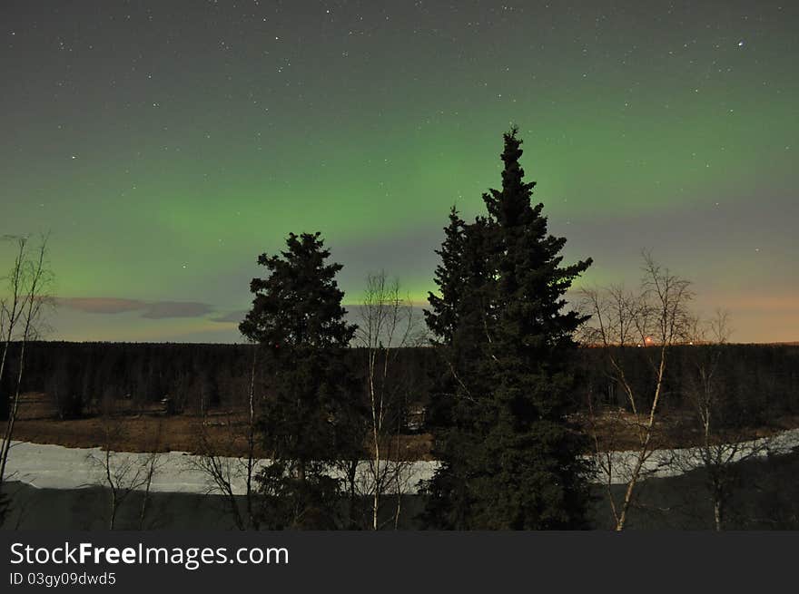 Kenai river alaska with soft green aurora on the horizon. Kenai river alaska with soft green aurora on the horizon