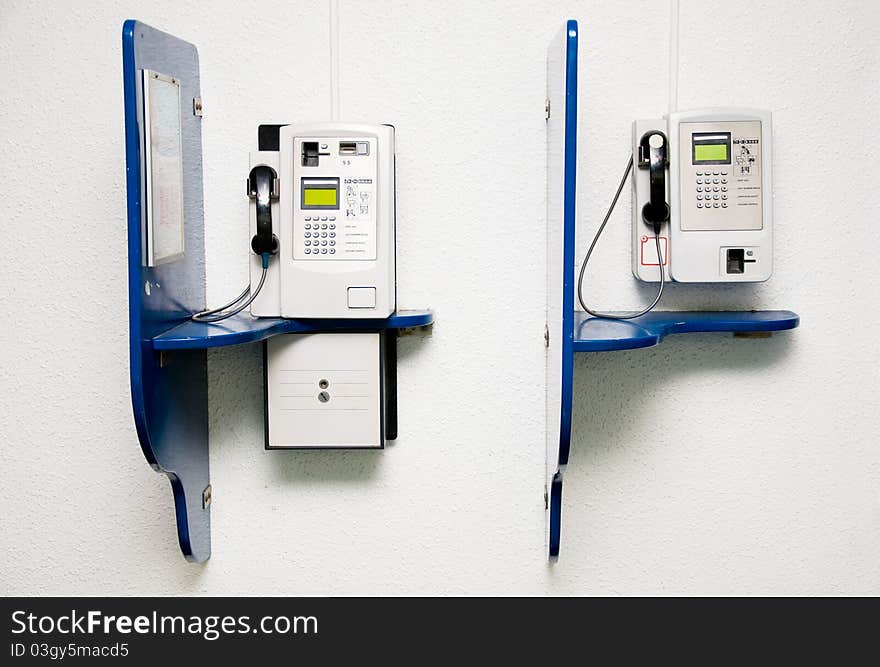 Two public telephone on wall