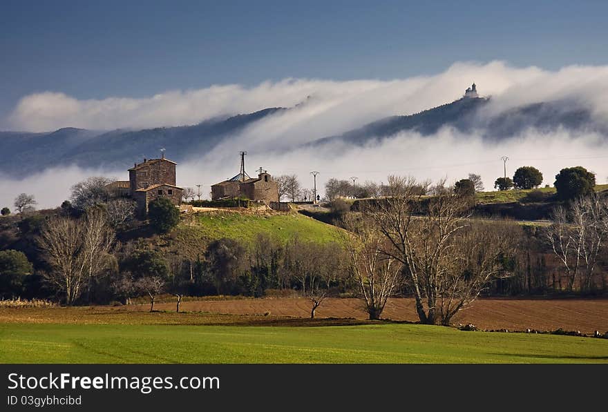 Stone palace in the field with fog.