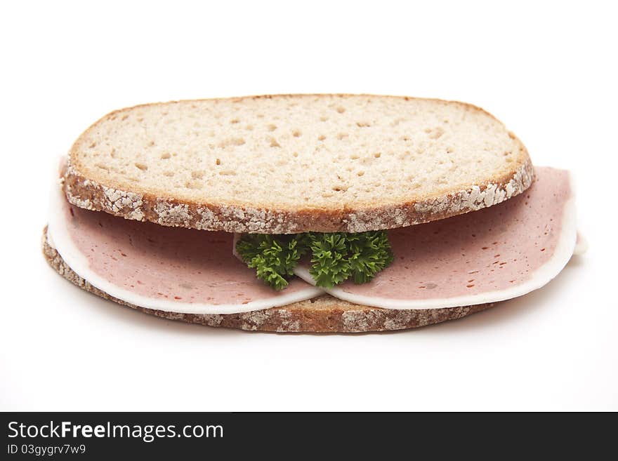 Liver sausage with parsley on wheat bread. Liver sausage with parsley on wheat bread