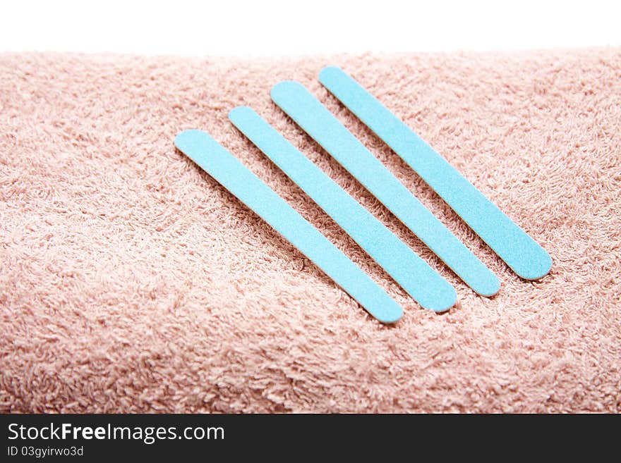 Blue fingernail files on terry cloth towel