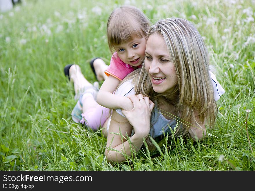 Mother and her daughter in the park on  sunny  day