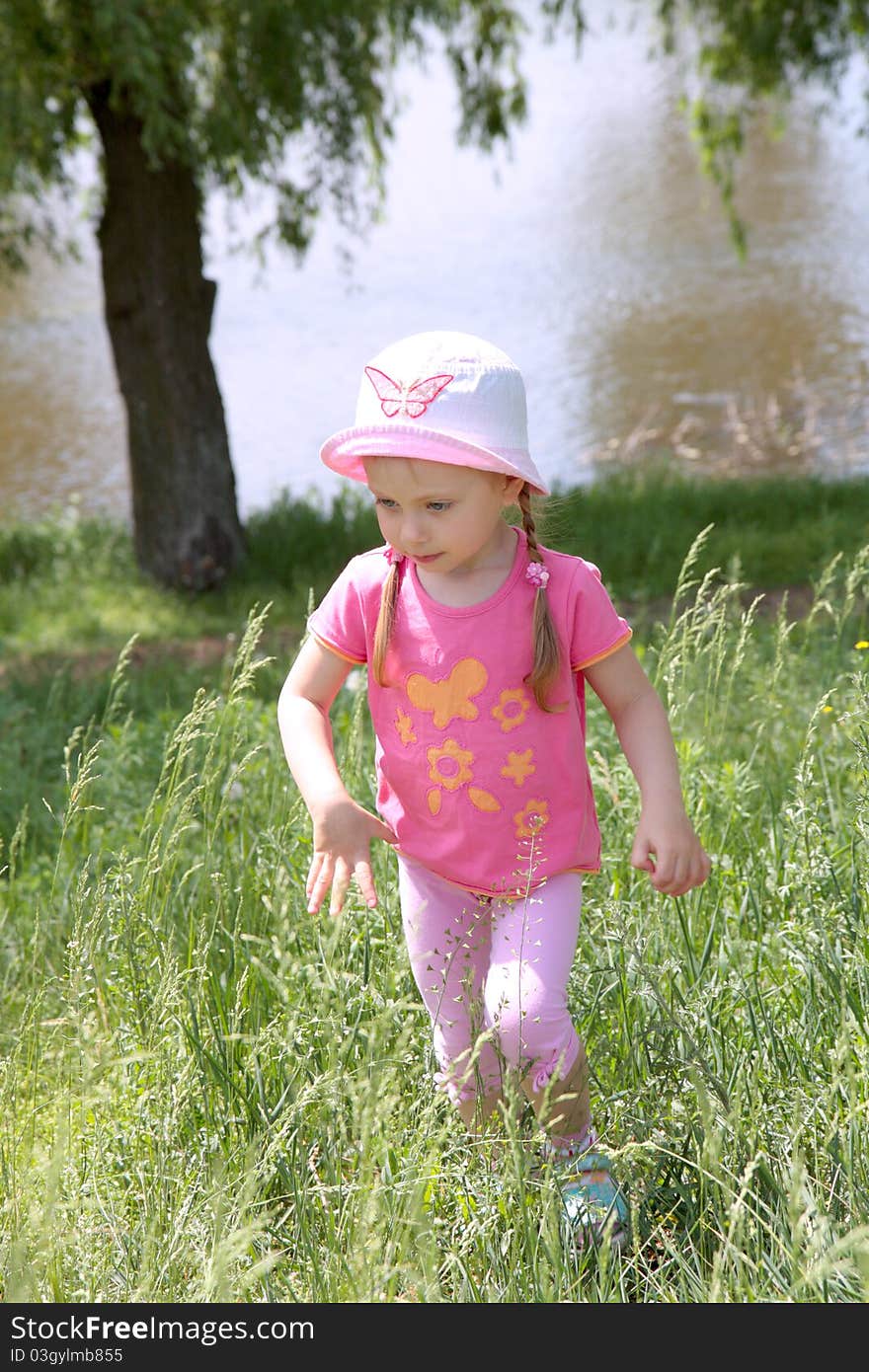 Sweet happy little a girl in a park. Sweet happy little a girl in a park