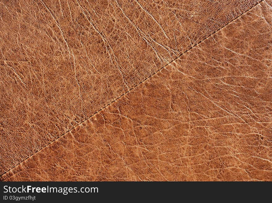 Brown leather texture / Brown leather with stitching going across and diagonal.